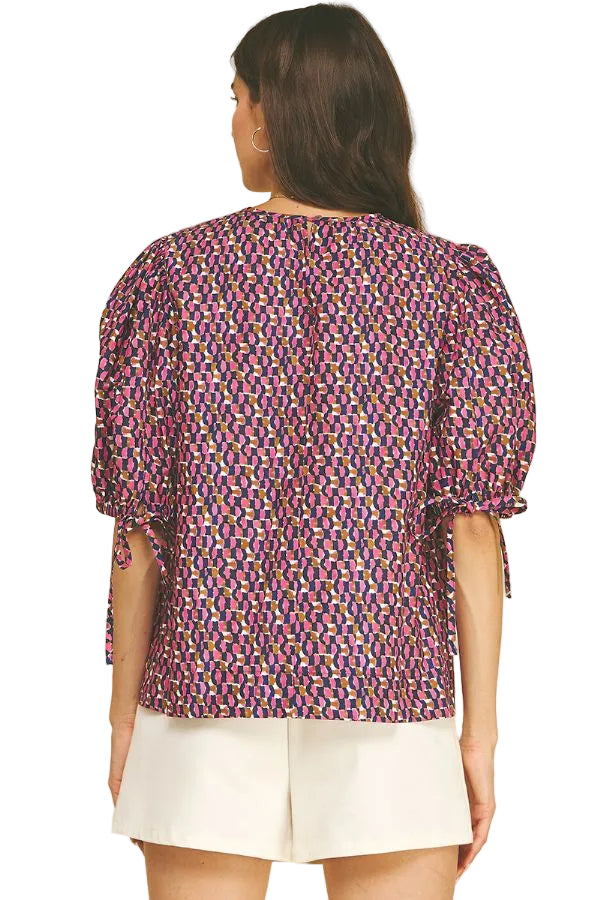 Another view of the Geometric Print Puff Sleeve Blouse in navy and pink by PINCH, from Chatsworth Boutique in Fairhope, Alabama.