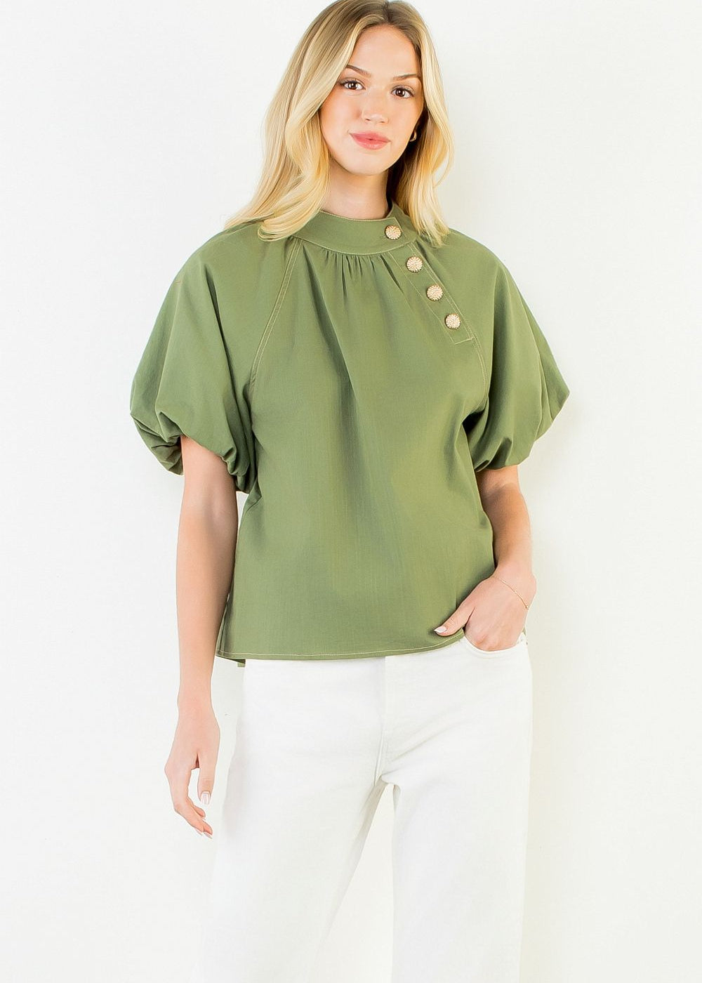 A model wearing the Olive Gold Button Blouse by THML, a woven button-up top in olive with gold button detail, from Chatsworth Boutique in Fairhope, Alabama.