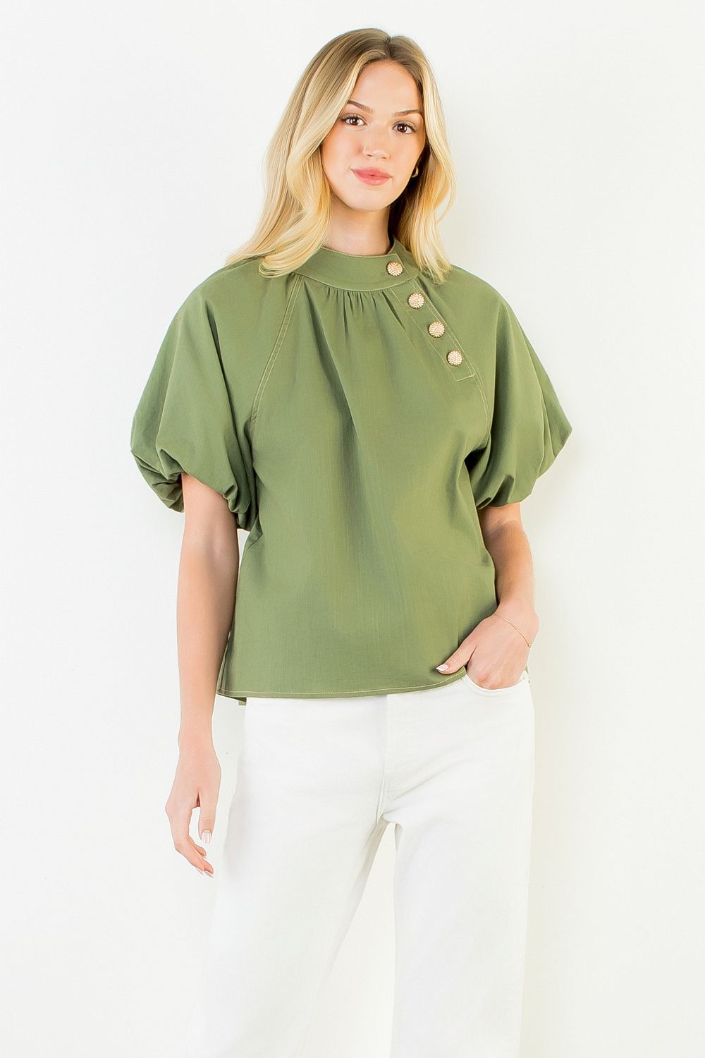 A model wearing the Olive Gold Button Blouse by THML, a woven button-up top in olive with gold button detail, from Chatsworth Boutique in Fairhope, Alabama.