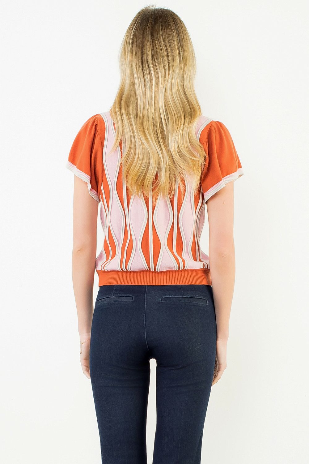 Front view of the Orange Ruffle Knit Blouse by THML, showing the ruffle detail and wavy print, from Chatsworth Boutique.