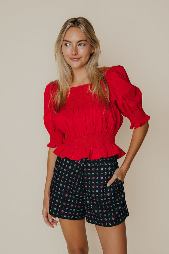 Close-up detail of the ruffle hem and stitching on the Ruby Top in red by LaRoque, from Chatsworth Boutique.