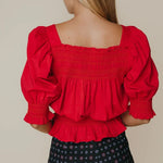 Another front view of the Ruby Top in red by LaRoque, showing the peplum silhouette, from Chatsworth Boutique in Fairhope, Alabama.