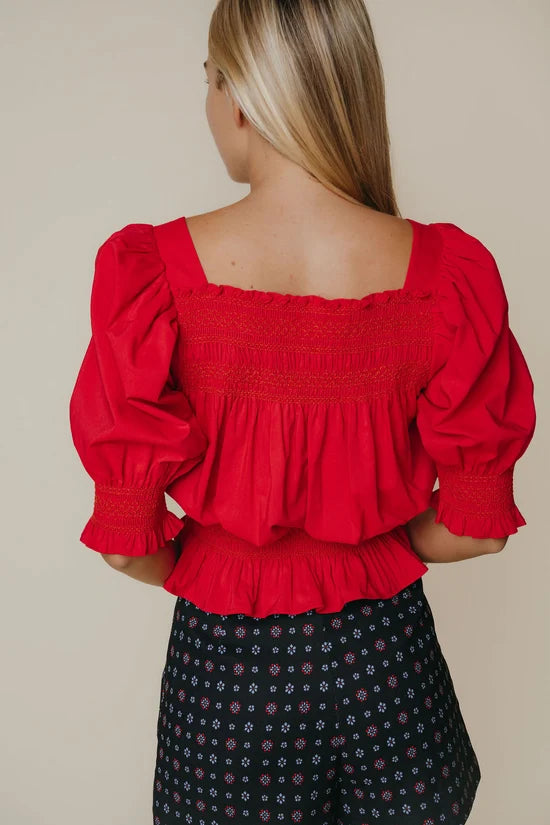 Another front view of the Ruby Top in red by LaRoque, showing the peplum silhouette, from Chatsworth Boutique in Fairhope, Alabama.