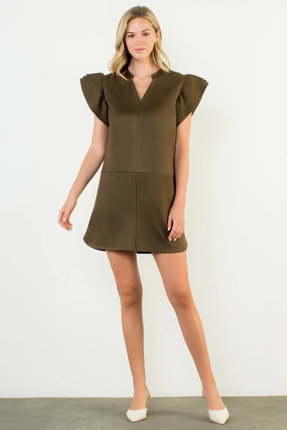 Woman wearing a green dress against a white background