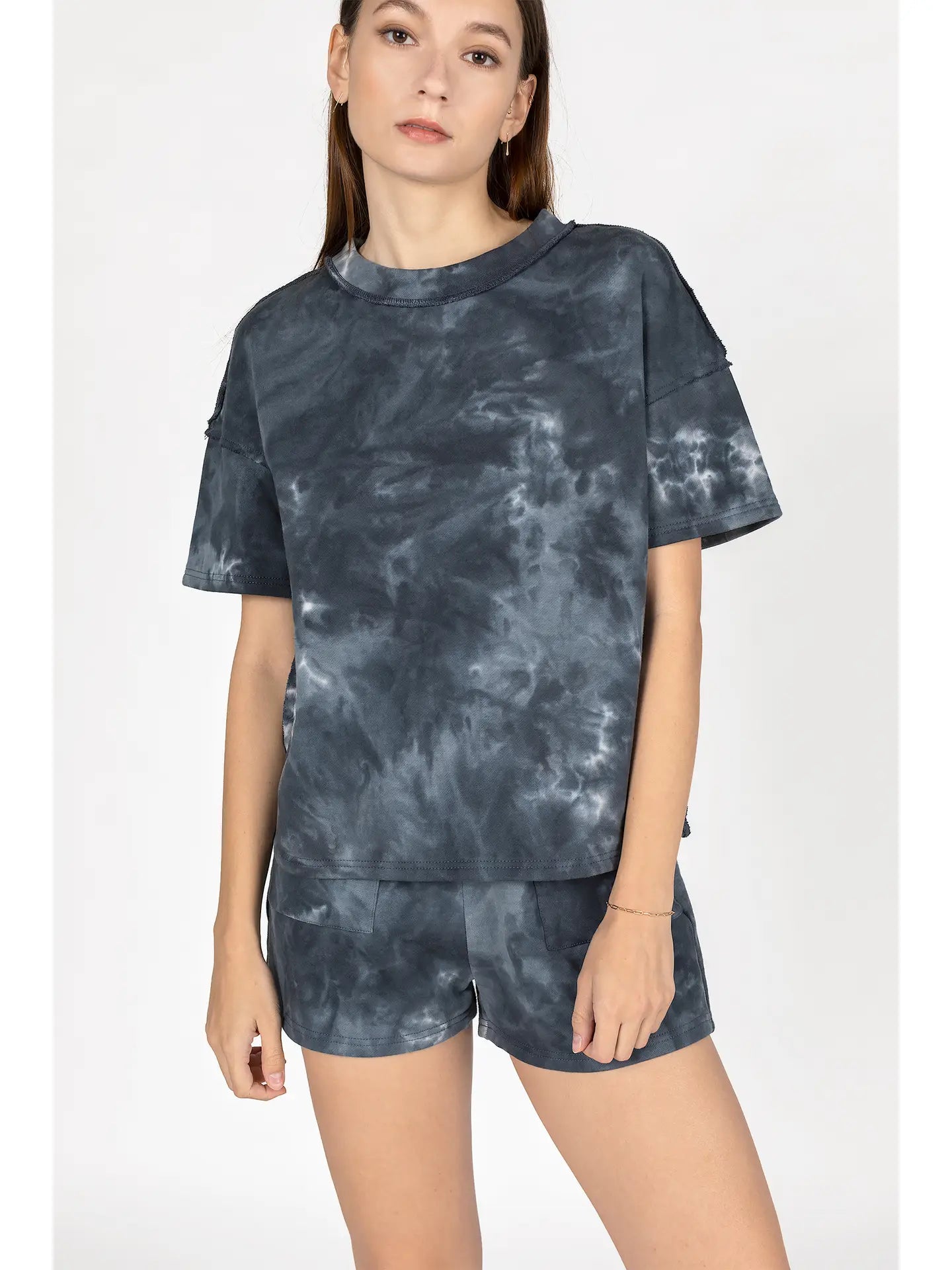 Person wearing a tie-dye outfit on a white background
