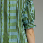 Close-up detail of the ruffle neckline and smocked sleeve on the Stripes and Dots Blouse in green by Entro, from Chatsworth Boutique.