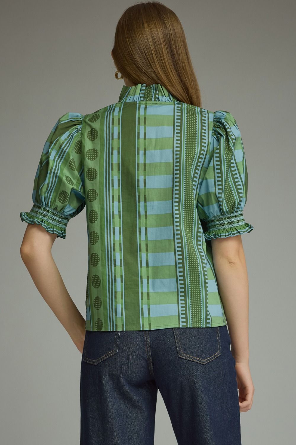 A model styling the Stripes and Dots Blouse in green by Entro, a green and teal mixed print top, from Chatsworth Boutique in Fairhope, Alabama.