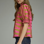 Close-up detail of the ruffle neckline and smocked sleeve on the Stripes and Dots Blouse in pink and chartreuse by Entro, from Chatsworth Boutique.