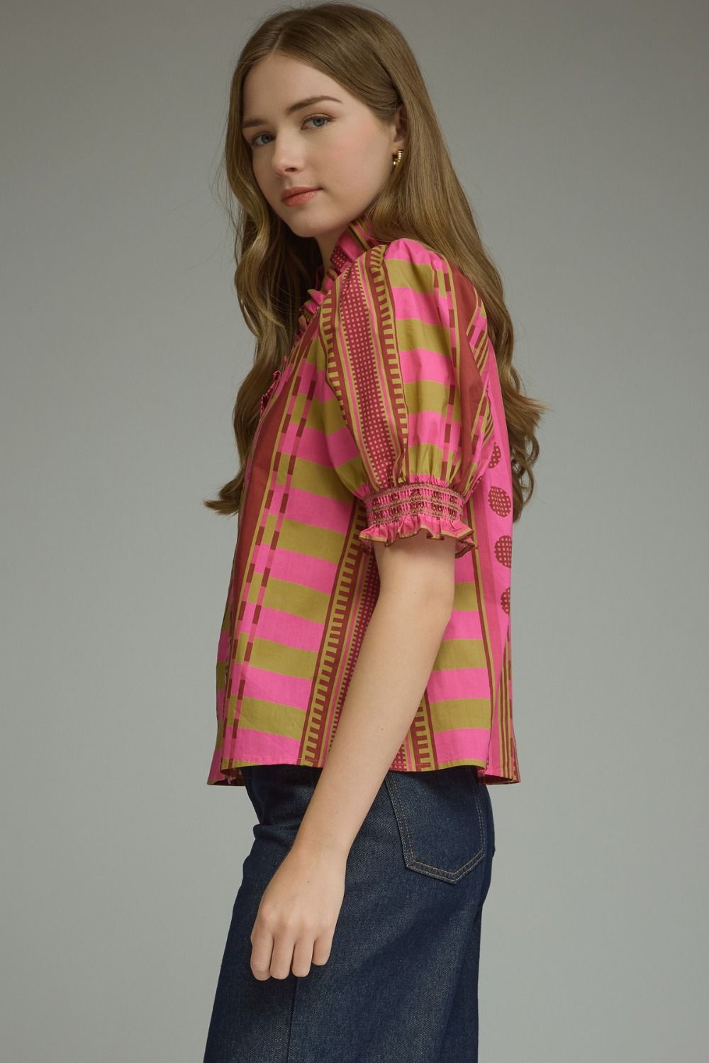 Close-up detail of the ruffle neckline and smocked sleeve on the Stripes and Dots Blouse in pink and chartreuse by Entro, from Chatsworth Boutique.
